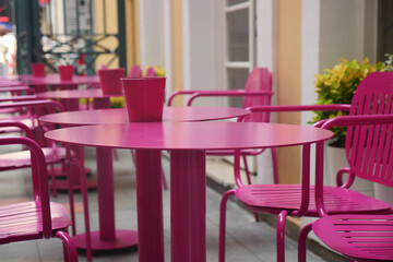Vibrant pink cafe seating in a sunny outdoor area