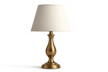 Golden table lamp with a creamy white fabric lampshade illuminating an elegant interior, cut out on a transparent background