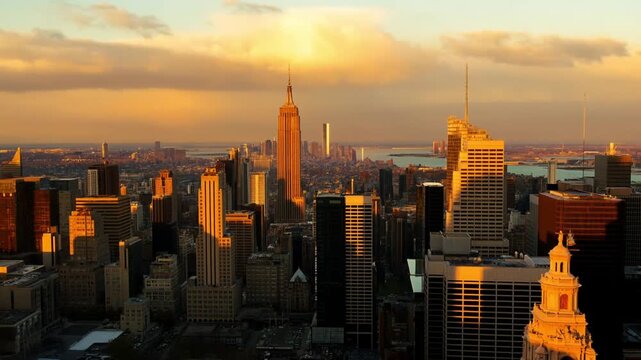 A majestic timelapse of a modern metropolitan skyline at golden hour with slow-moving clouds casting shadows over sun-reflecting windows against a colorful sky, concept of urban beauty and time passag