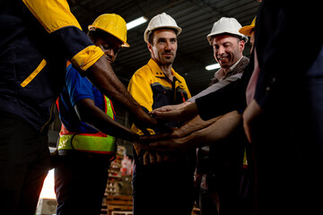 Group of multiracial colleagues joining hands in meeting.