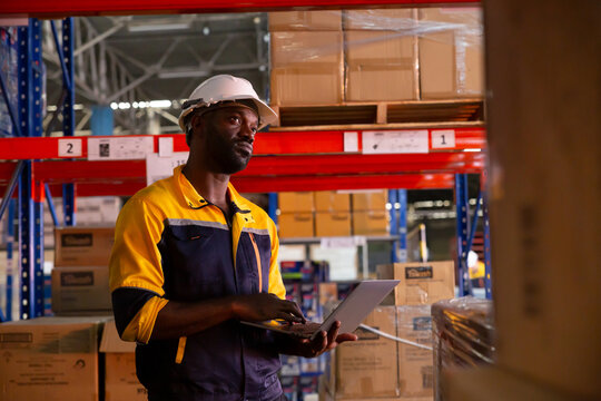 Black man on laptop for inspection, inventory and online stock