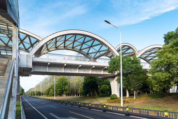 Pedestrian bridge against blue sky