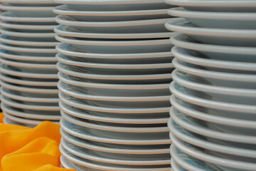 Close up photo of white stacked clean ceramic plates ready for serving food at a formal buffet setting