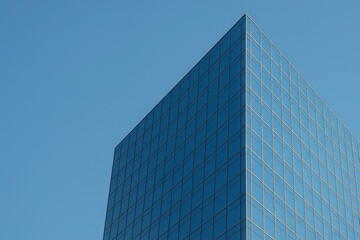 Obraz premium Modern Minimalist Corporate Glass Skyscraper Corner Architecture Against Clear Blue Sky