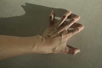 A woman's hand with bulging tendons