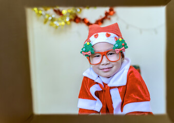 Child in Santa Outfit Sharing Festive Joy Open Present Gift Box, Happy Kid Opening Giftbox in Xmas Tree Home Interior
