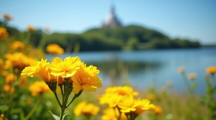 Vibrant yellow flowers in the foreground with a tranquil lake and distant temple