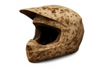 Motocross helmet covered in mud and dirt, symbolizing safety and the thrilling intensity of biking and extreme racing
