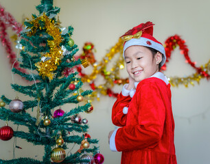 Happy a little girl with Xmas morning in decorated living room.Christmas