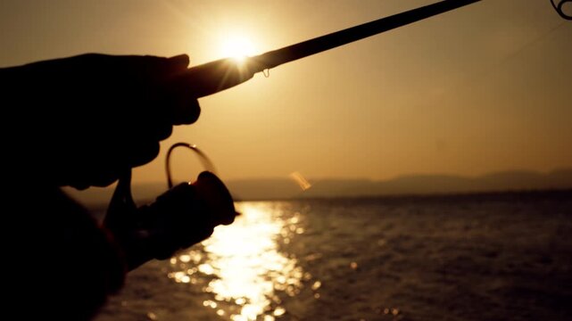 Macro view of fishing rod loop against sunset light and water, ideal for fishing and nature concept