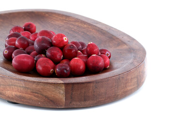 Fresh cranberries in a wooden bowl, perfect for holiday recipes and healthy eating