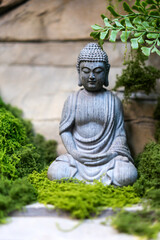 The Buddha stone statue on the stone wall