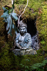 The Buddha stone statue on the stone wall
