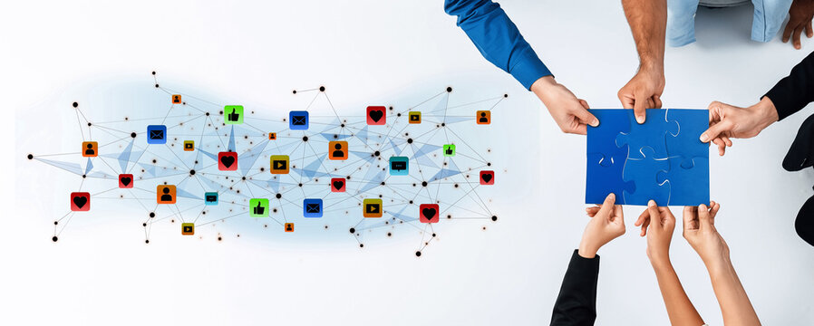 Hands come together to connect puzzle pieces in a digital workspace, symbolizing teamwork and collaboration in a tech-driven environment. Emphasizing unity and innovation. Trope