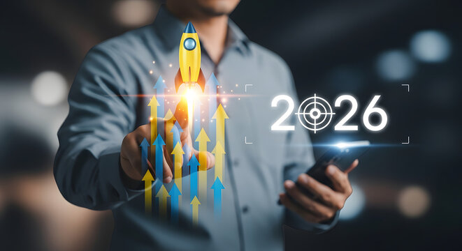 Man with digital display of 2026 target and rising graph for business success