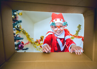 Child in Santa Outfit Sharing Festive Joy Open Present Gift Box, Happy Kid Opening Giftbox in Xmas Tree Home Interior