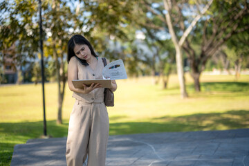 Busy woman multitasking on phone and tablet outdoors