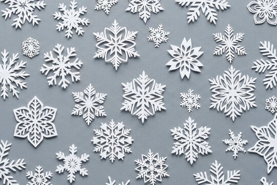 An elegant winter holiday composition featuring dozens of white decorative snowflakes