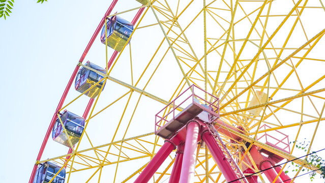 Colorful Ferris wheel at Panfilov Park in Bishkek Kyrgyzstan, showcasing vibrant design and joyful atmosphere, perfect for leisure and entertainment