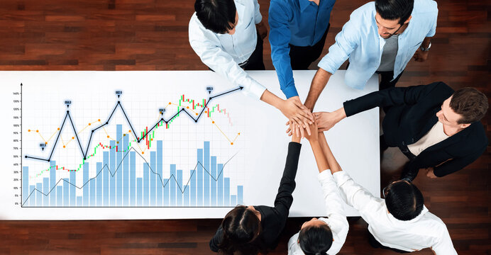 Diverse team forming a supportive circle with hands united over financial growth charts, symbolizing collaboration, strategy, and teamwork in a business environment. Scalp