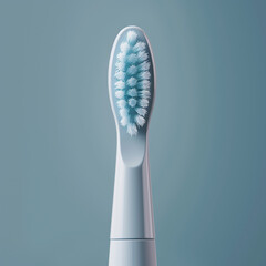 Electric toothbrush head with blue bristles on grey