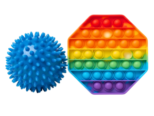 Blue spiky stress ball and rainbow pop it toy isolated on transparent background