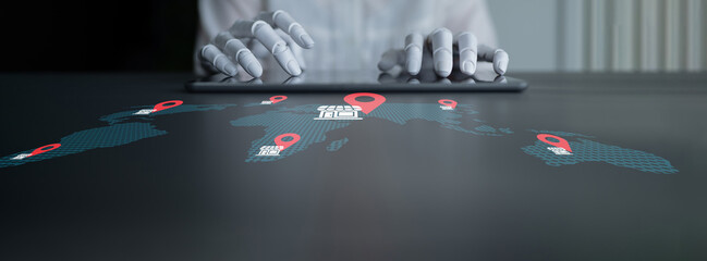 A close-up of hands typing on a tablet with digital maps and location markers, emphasizing global connectivity and the role of technology in modern workspace environments. Gantry