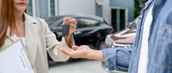 Fototapeta premium lease, rental car, sell, buy. Dealership manager send car keys to the new owner. Sales, loan credit financial, rent vehicle, insurance, renting, Seller, dealer, installment, car care business