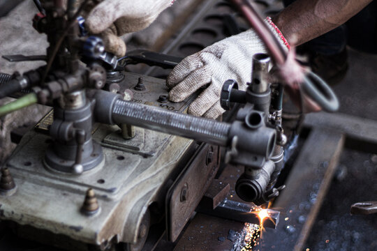 Worker Operating Gas Cutting Machine on Steel Plate - Powered by Adobe