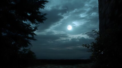 Fototapeta premium A luminous moon shines through dramatic clouds over a mysterious landscape with trees and ancient stone structures at night