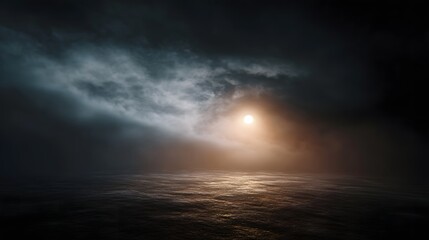A dramatic moody seascape with the sun obscured by swirling mist and dark clouds over rippling water