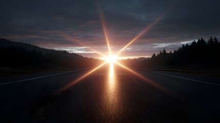 Dramatic sunburst with flare on a road leading towards the horizon at dawn with silhouetted trees and dark clouds