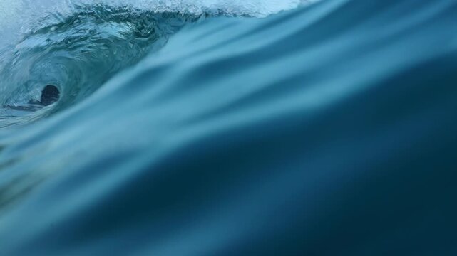 Underwater and above water close up footage of an Ocean wave in slow motion