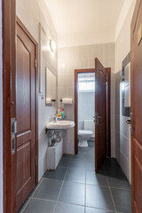 Small Tiled Restroom Interior with Sink and Toilet