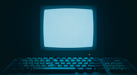 Vintage computer, embodying the evolution of technology and the digital age, features a retro display screen with an illuminated glow, accompanied by an old-fashioned keyboard.