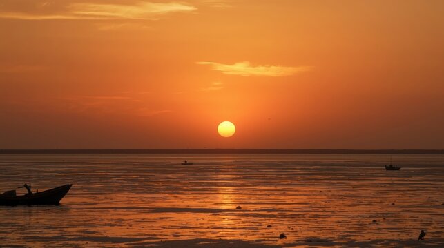 Vibrant orange sunset over calm ocean with a small boat - Powered by Adobe