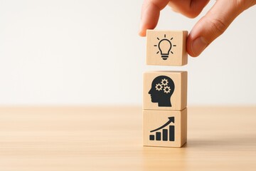 Person stacking wooden blocks with icons representing ideas, mindset, and growth. Concept of innovation, cognitive development, and professional advancement.