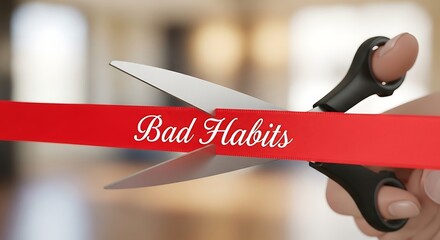 Scissors cutting a red ribbon with the words bad habits written on it symbolizing breaking free