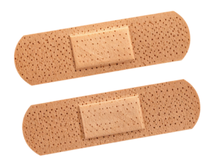Two adhesive bandages, close-up on a dark background
