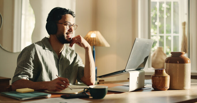 Happy, man and headphones for video, laptop and watching design tips on website, listening and home. Creative, graphic designer and person with tech for tutorial, writing and learning for remote work