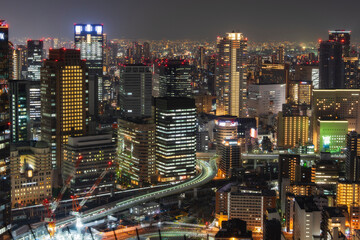 Obraz premium High angle view of illuminated buildings in Osaka city at night