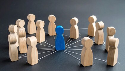 Blue figure connected to wooden figurines in circular network on dark surface