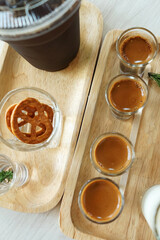 Close up Iced black Americano and espresso shots served with fresh milk and crispy mini pretzel