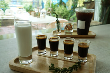 Close up Iced black Americano and espresso shots served with fresh milk and crispy mini pretzel