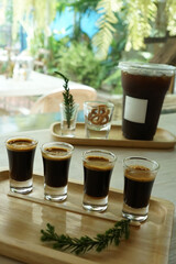 Close up Iced black Americano and espresso shots served with fresh milk and crispy mini pretzel
