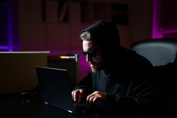 Hacking personal information safety. Crypto data hacking. Hacking hunting for crypto currency. Hacker in hoodie dark night theme. Digital data security concept. Hackers attack.