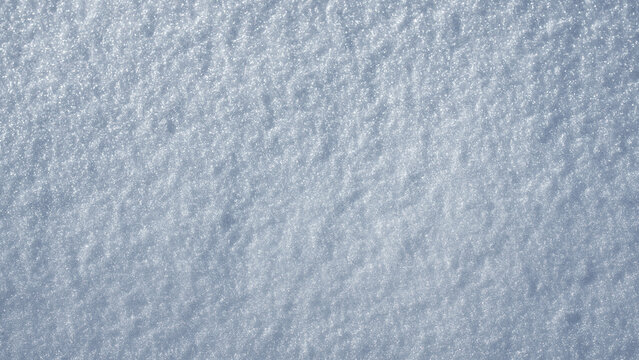 Snowy winter background with snow texture. Snow covered surface in daylight. Winter field pattern. Snow backdrop with natural frost details. Winter frozen texture with sparkling snow.