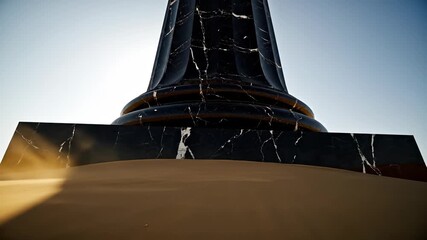 Sunlight flares behind a mysterious dark monument in a vast desert landscape creating a dramatic and aweinspiring scene.