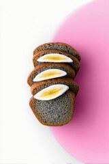 A stack of bread slices with banana slices on top, arranged on a pink and white background.