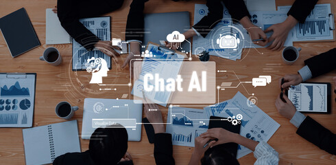 Bird-eye view of colleagues discussing data and charts related to artificial intelligence in a meeting, showcasing teamwork and collaboration in a professional setting. Trope